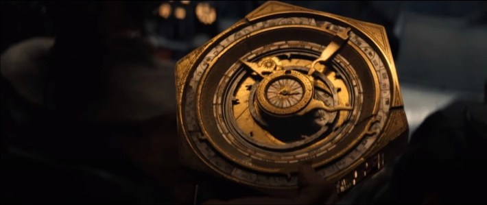 A handheld machine made up of dials and gears.