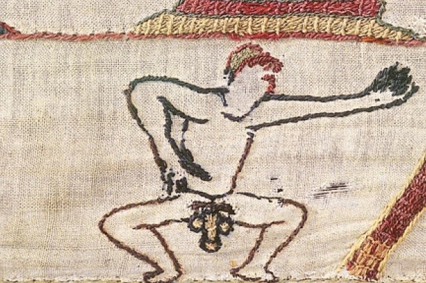 An embroidered naked man, penis pointing downwards.
