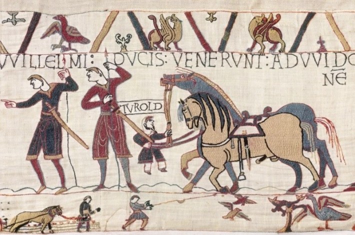 Embroidered tapestry of men leading horses with big penises.