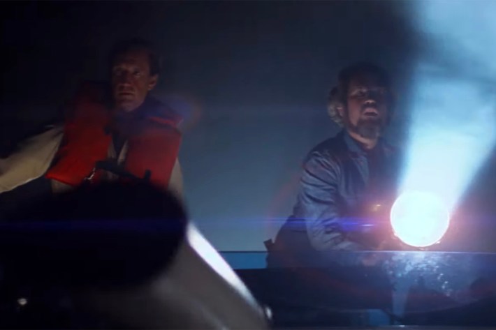 men on boat with search light