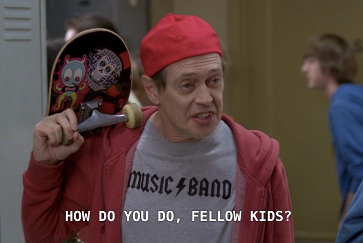 An older man dressed like a teen, holding a skateboard and asking "How do you do, fellow kids?"