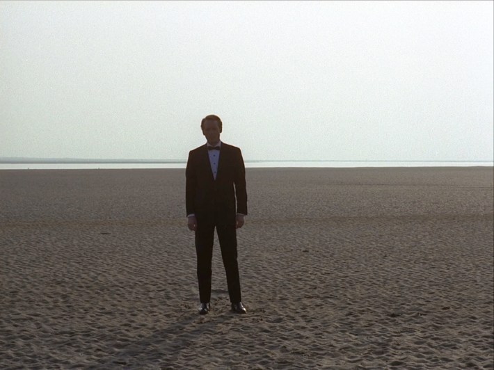 Six in tux on beach