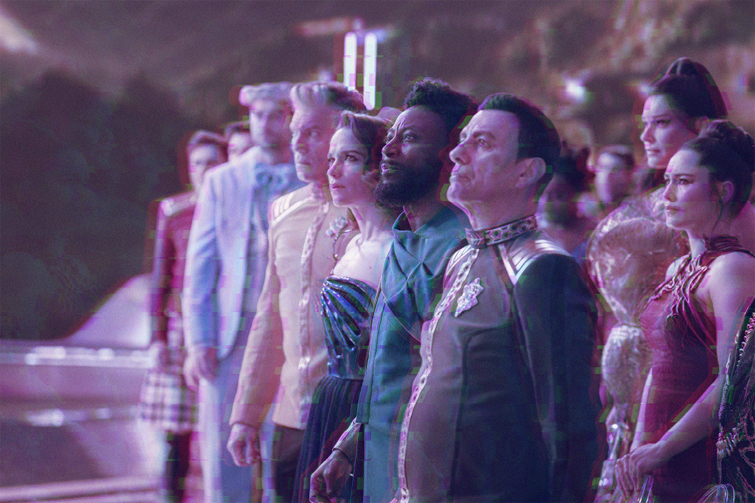 Dr. Roger Korby (Cillian O'Sullivan), Capt. Pike (Anson Mount), Batel (Melanie Scrofano), Dr. MíBenga (Babs Olusanmokun), Una (Rebecca Romijn), and Laían (Christina Chong) stand in a line with their attention directed upward