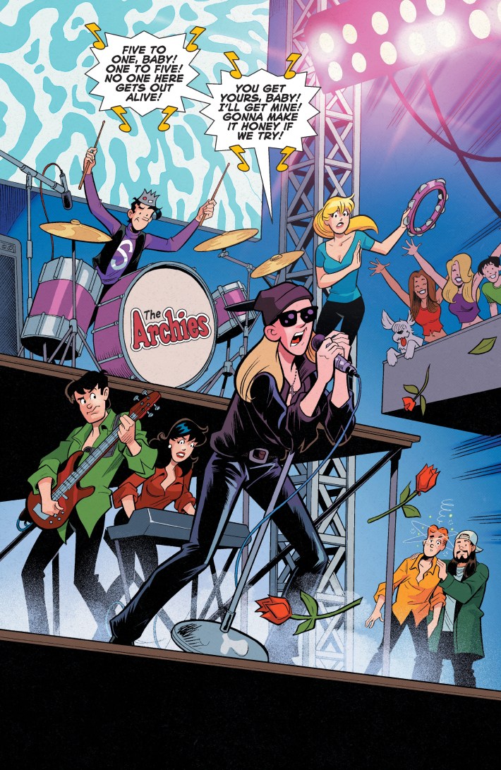 A comic panel of a massive rock concert. A bunch of teens are playing instruments while a man dressed in black sings The Doors' "Five to One".