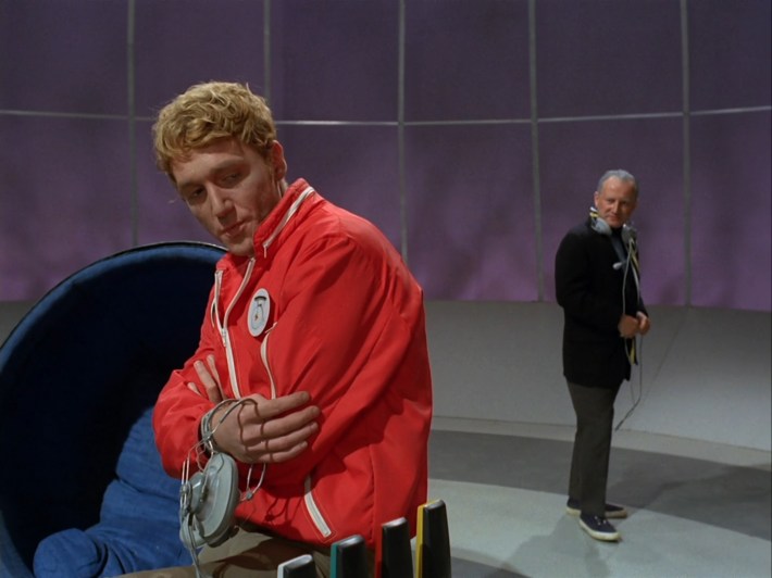 Eight is hunched over looking pouty as Two stands behind him judgmentally