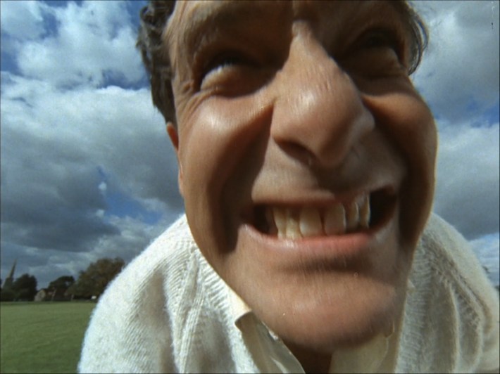 A man's face close to the camera.