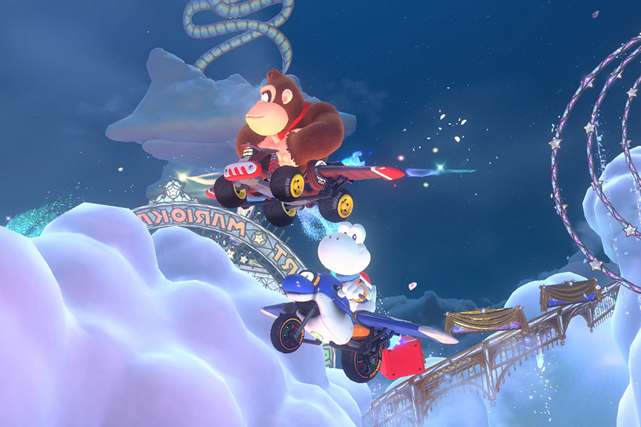 Donkey Kong and white turtle looking creature flying in cars in Mario Kart World