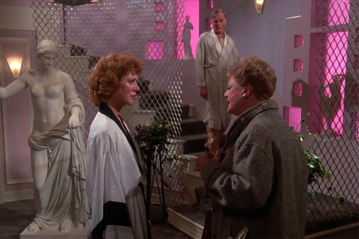 Jessica with woman and man in heinous, avant-garde pink and Roman themed "apartment"
