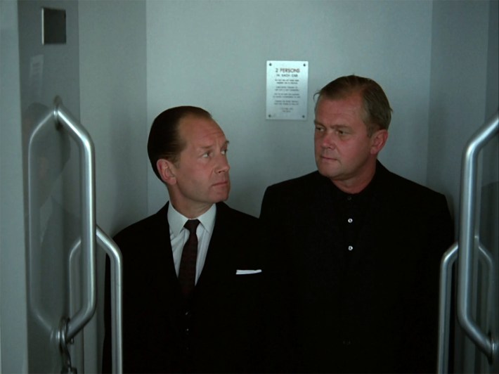 Colonel Six and man in elevator