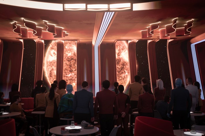 Starfleet standing on deck in front of fiery celestial body