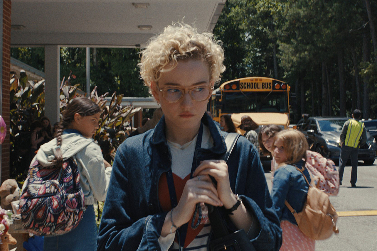 Julia Garner walking away from elementary school kids