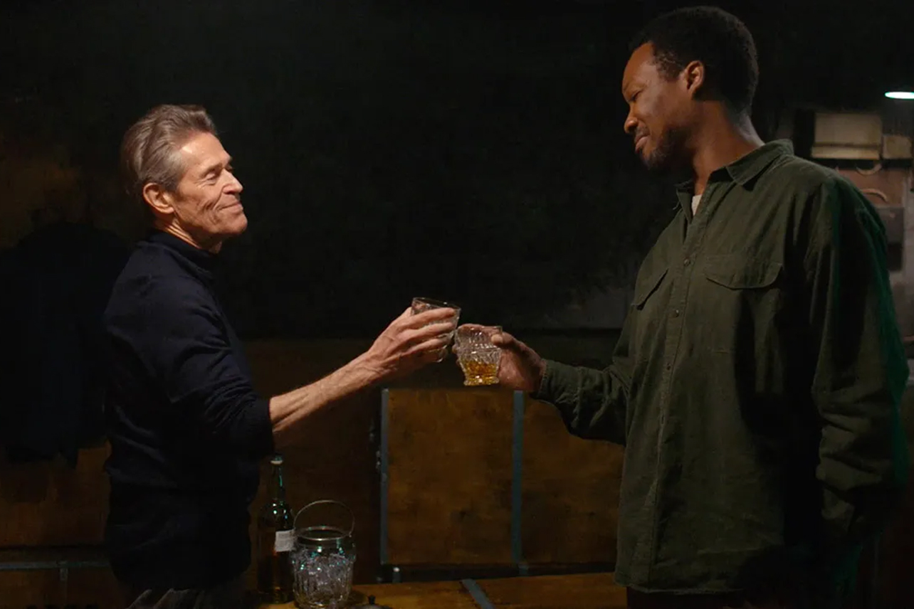 Willem Dafoe toasting with Corey Hawkins