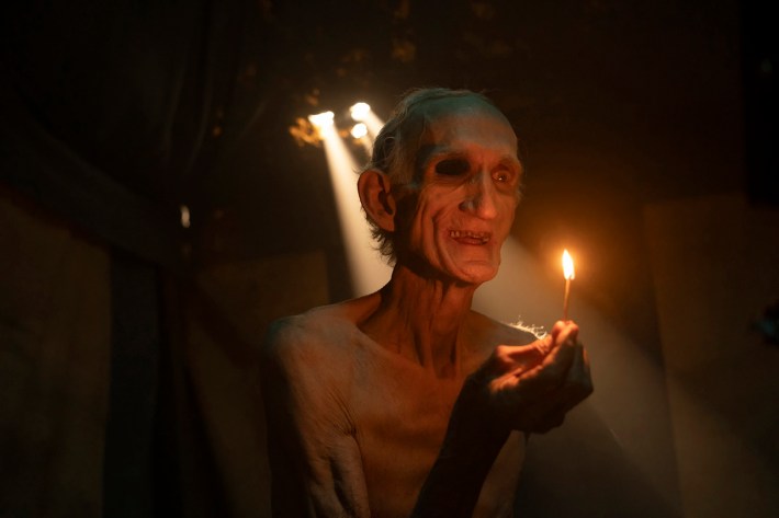 Skinny man with match