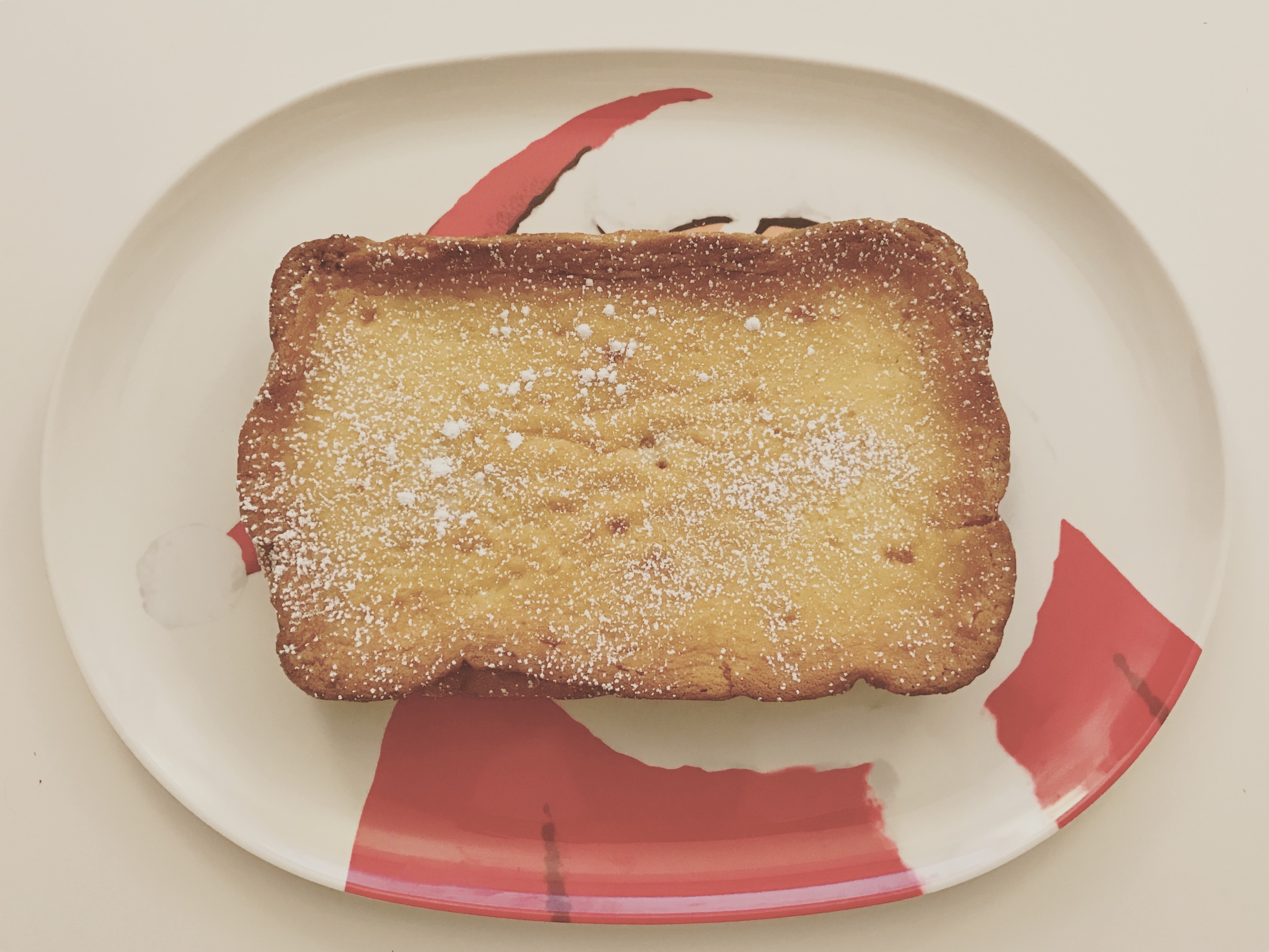 gooey butter cake on a melamine platter illustrated with a cartoon santa