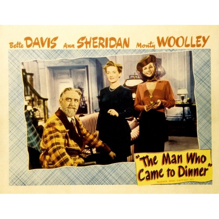 Lobby card for the Man Who Came to Dinner, showing a man with a beard in a wheelchair and two well dressed women by a Christmas tree.