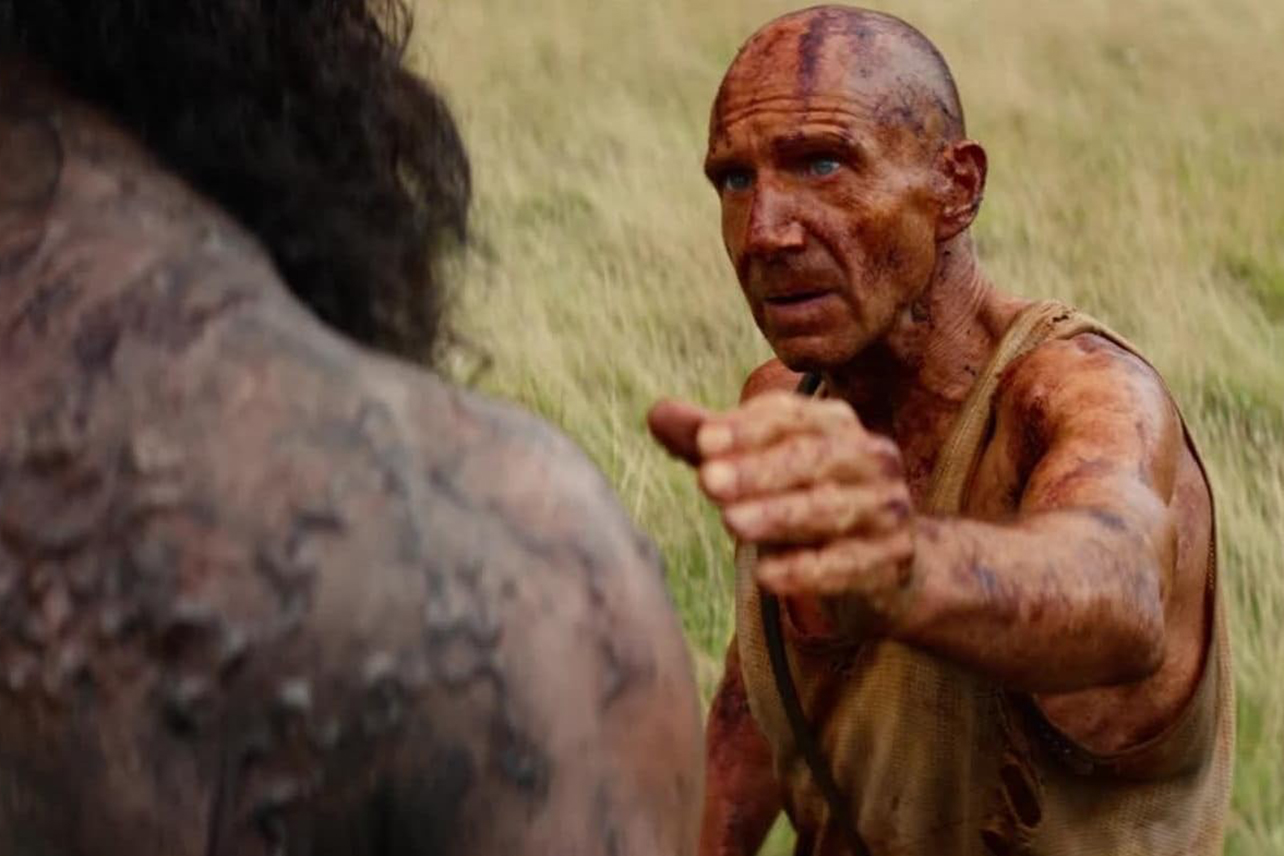 Ralph Fiennes in 28 Years Later, arm outstretched to touch monster