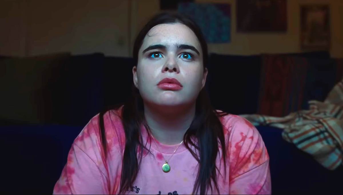 Person looking, wearing pink shirt, they have long hair