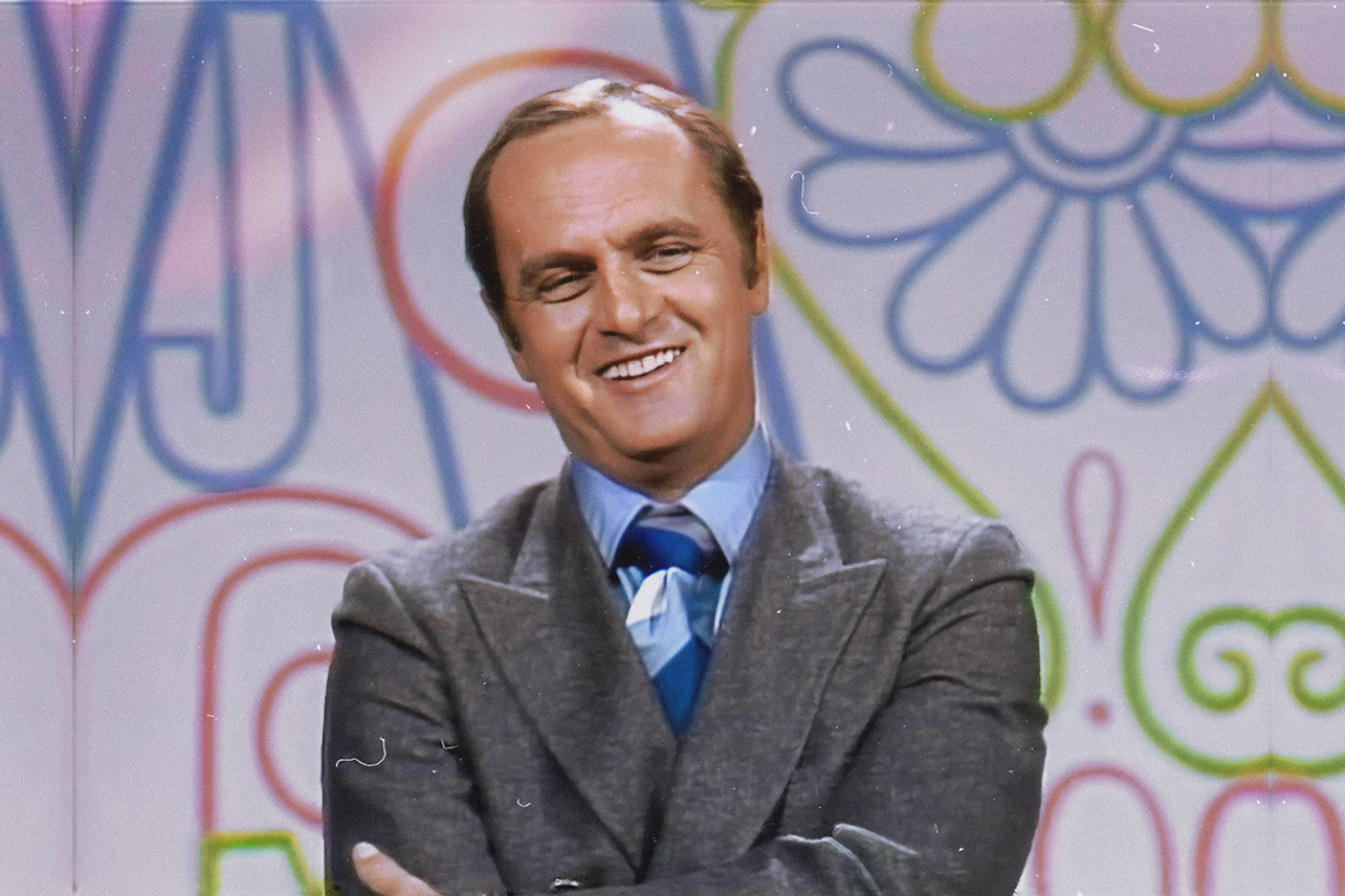 Bob Newhart standing in front of floral pattern backdrop