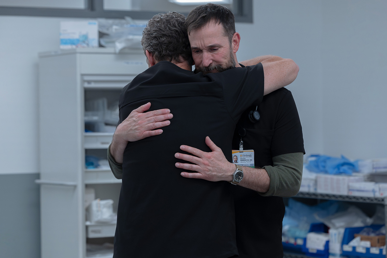 Noah Wyle's Pitt character hugging another person