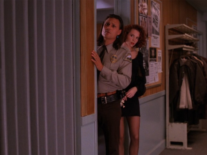 Deputy and woman peeking out of office