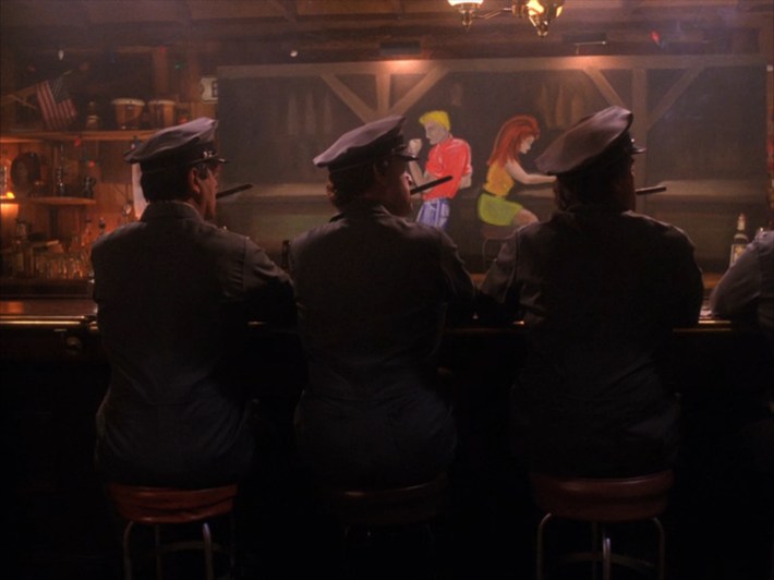 Men smoking cigars in a row