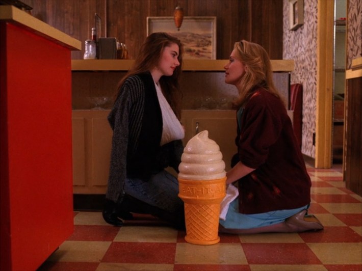 Women on floor with giant ice cream cone prop
