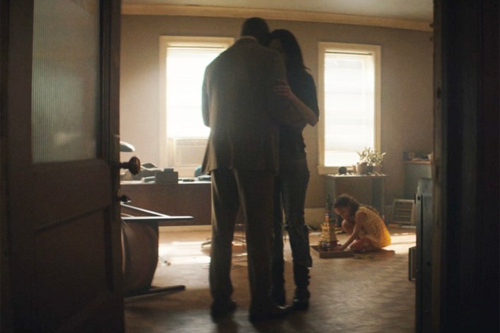 Luke and Jess hugging in Alias Investigations office, Danielle playing on floor