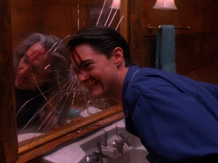 Dale cracking mirror with head, Bob in reflection