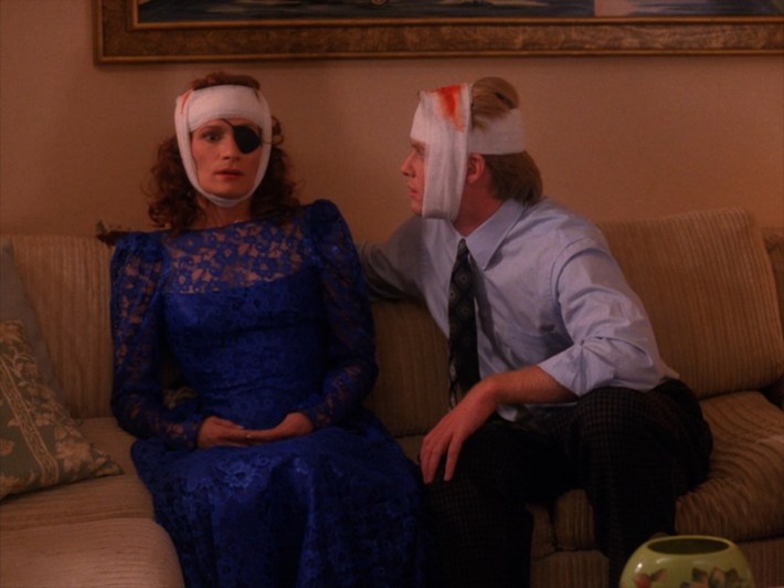 Nadine and man on couch in bandages