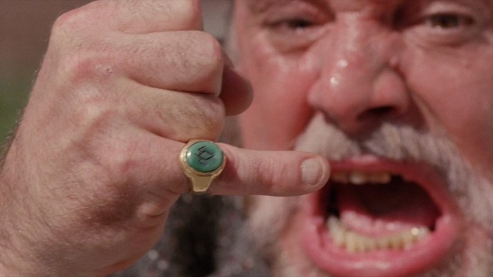 Man shouting and showing off pinky ring
