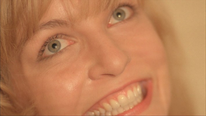 Closeup of Laura smiling creepily