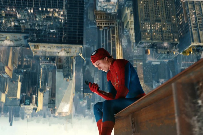 Spider-Man looking at phone upside down on girder