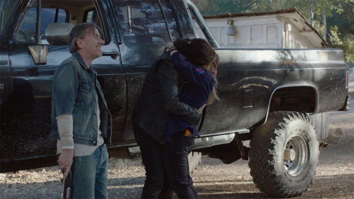 Tim Roth and couple hugging in front of truck