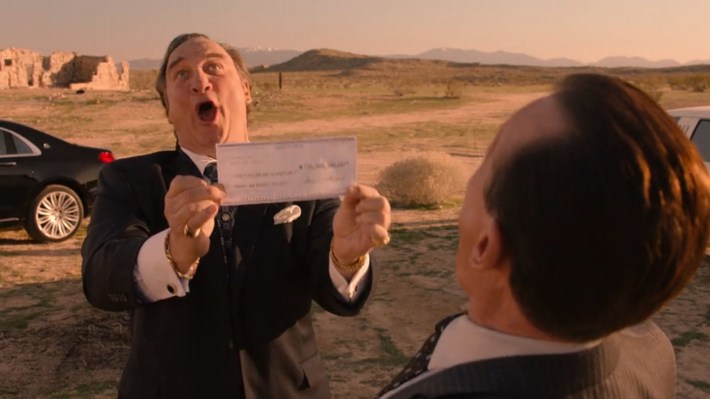 Belushi holding check