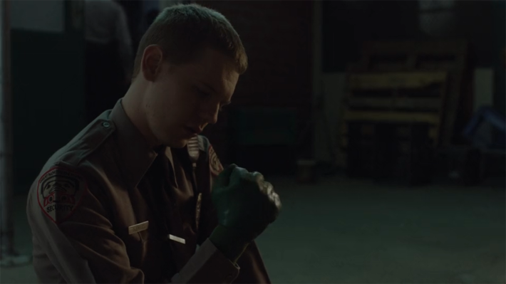Guard wearing green glove