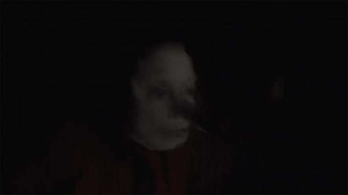 Creepy blurry face in dark